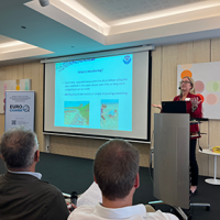 Dr. Amy V. Uhrin presents at the final meeting of the EUROqCHARM project in Brussels, Belgium (Credit: SALT Norway).