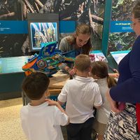A NOAA Marine Debris Program Education Specialist shared tips for preventing marine debris, including turning it into art, with museum visitors of all ages (Credit: NOAA).
