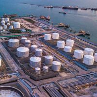 Aerial view of an industrial facility with several large-scale chemical storage tanks.